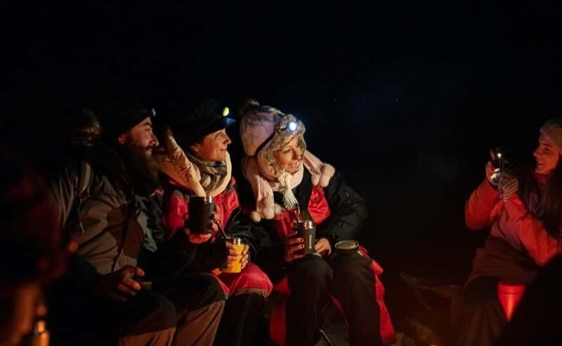 Tromsø: All inclusive Aurora Hunt with photos, food & drinks - Campsite waiting: thermal suits, bonfires, and that long exhale